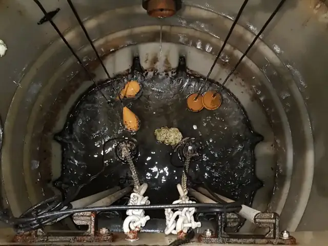 Engineer repairing and servicing a sewage pump station