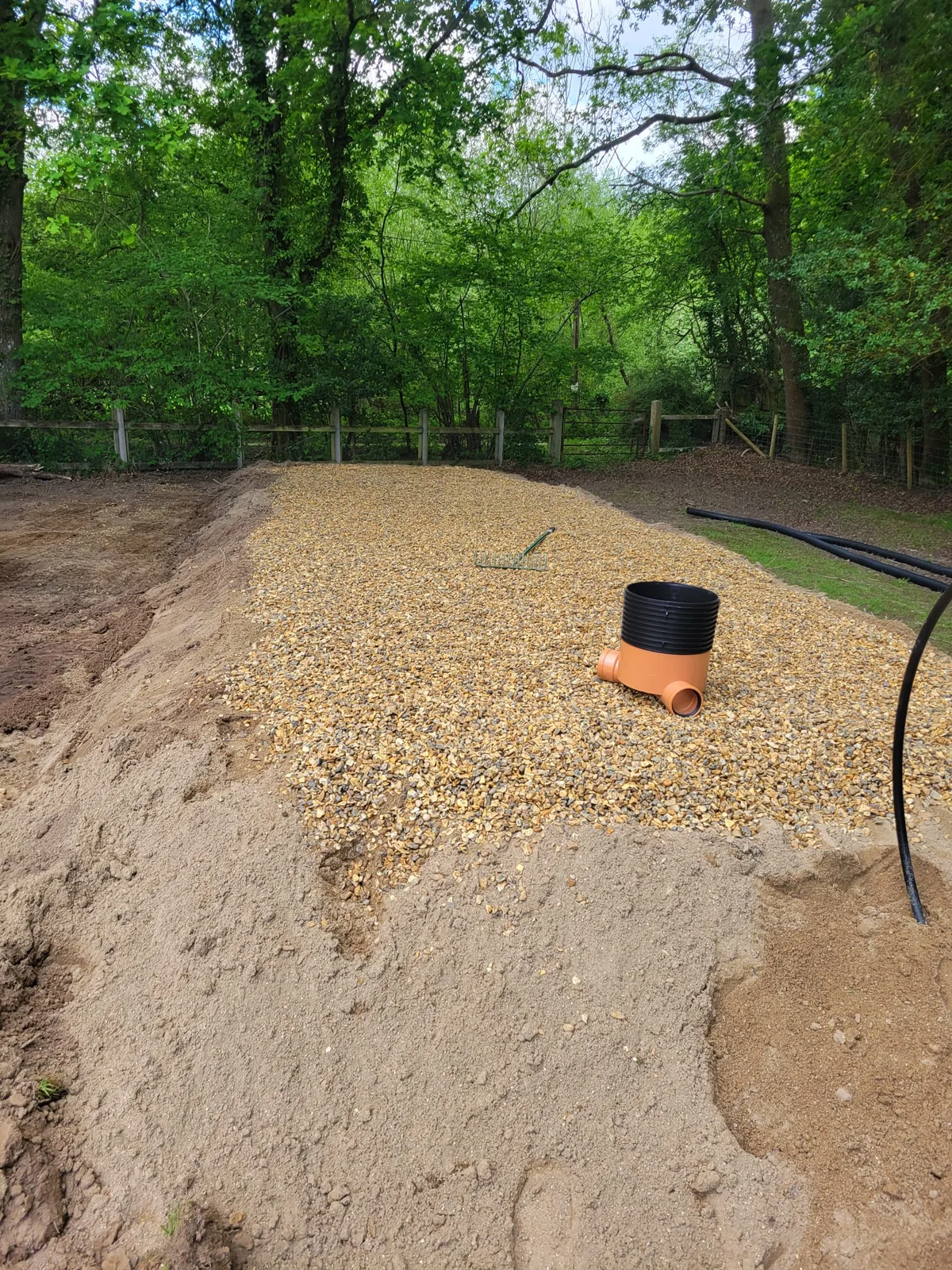 Drainage stone and distribution pipework installed across raised mound
