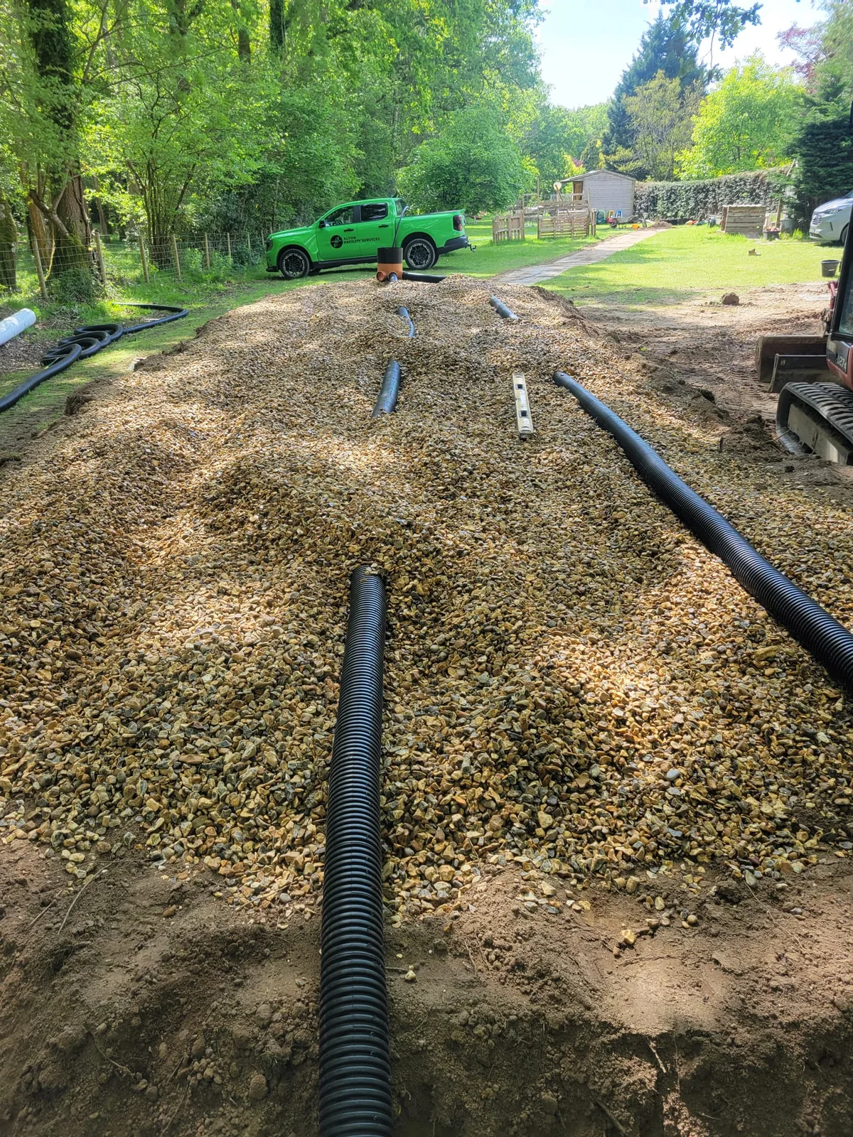 Inspection chamber and perforated pipework for raised drainage mound