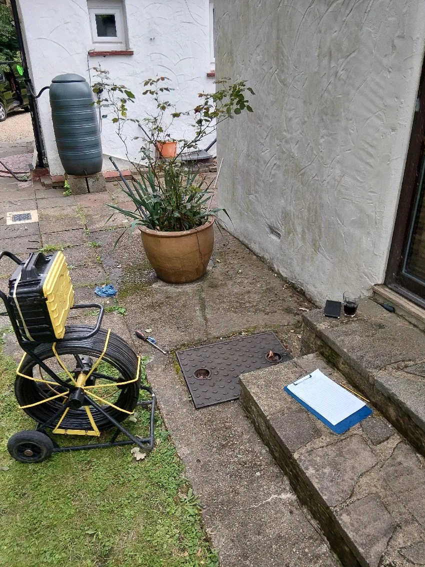 Drain camera equipment beside access chamber during pre-purchase drainage survey