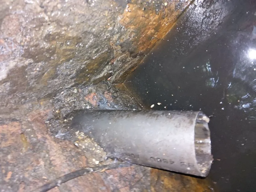 Outlet pipe inspection inside septic tank chamber
