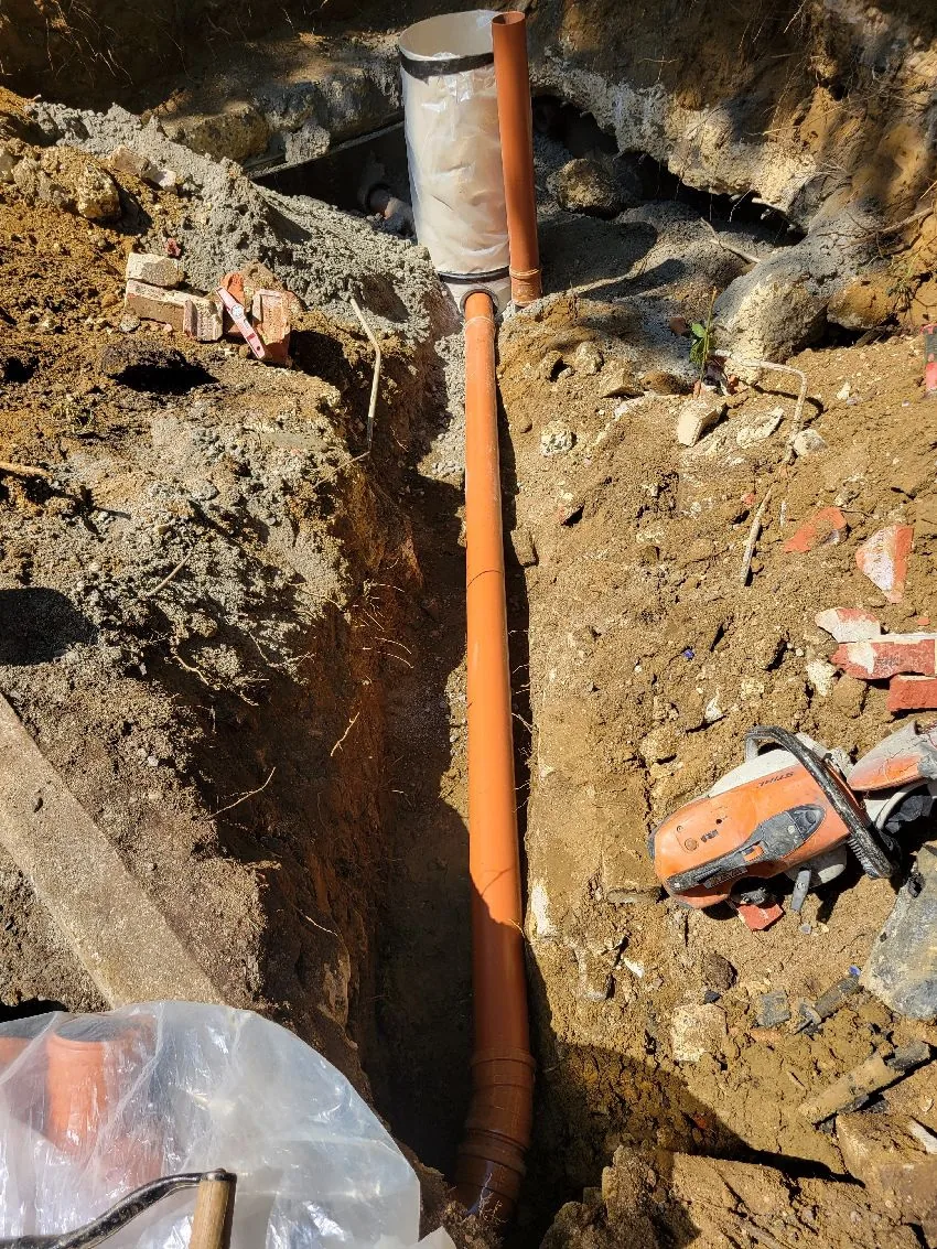 Excavated trench for septic tank replacement and discharge works