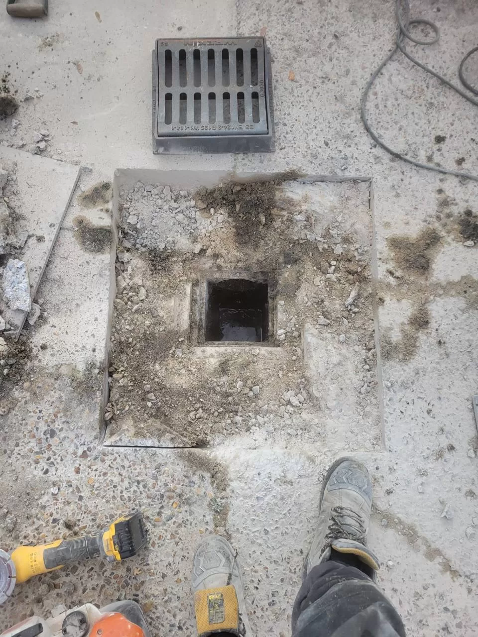 Excavated gully in concrete showing blockage