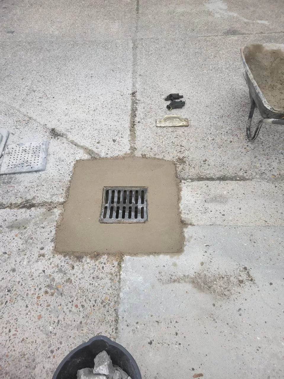 New heavy-duty gully lid installed and surrounded by fresh concrete