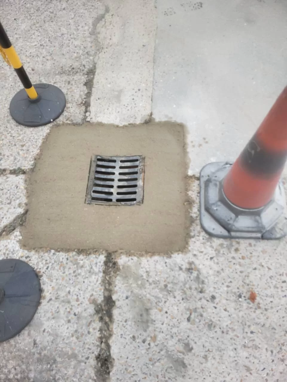 Completed gully repair with traffic cones nearby